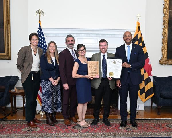 photo of mdot team receiving award from govenor moore, secretary flora, and secretary day.