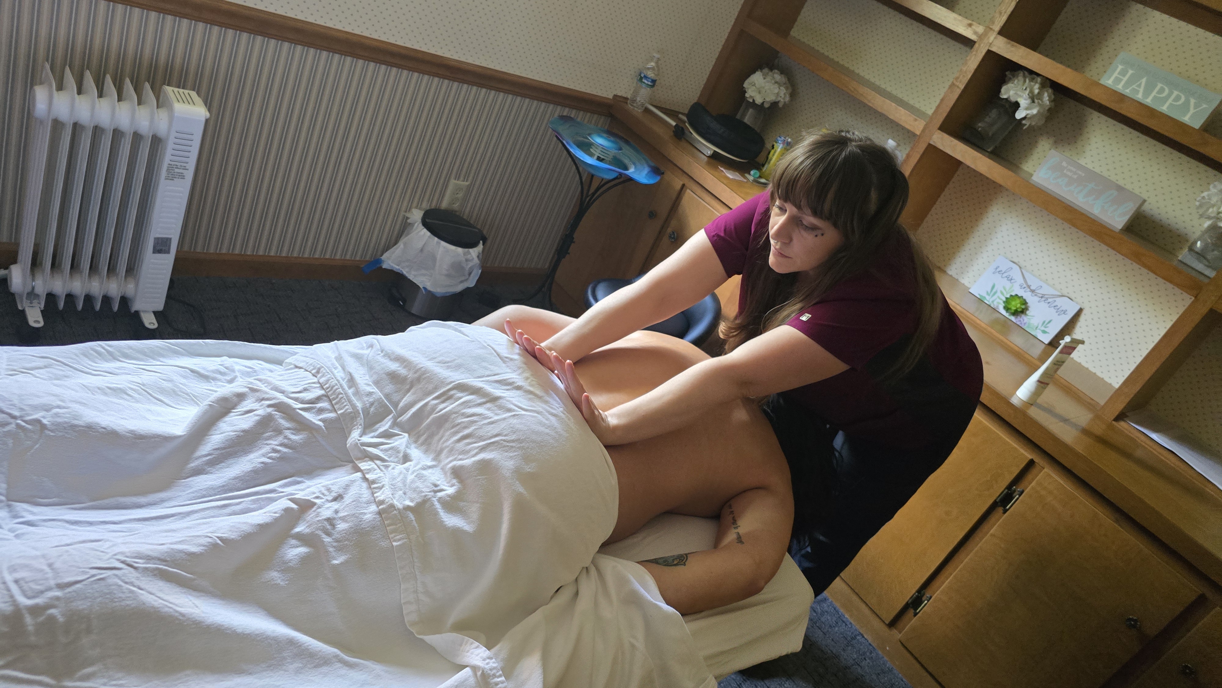 A licensed massage therapist working on a client during a relaxing massage session