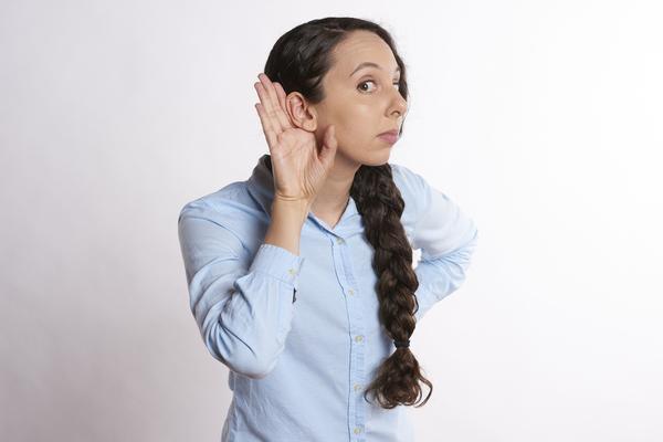 Young woman with her hands in the air like "I don't know!"