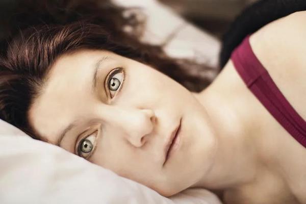 Image of woman lying awake at night