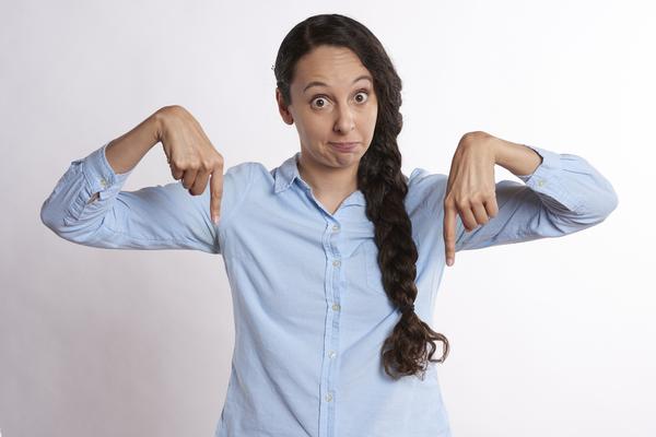 Woman pointing down with both hands toward answers to choose from