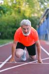 Middle aged man getting ready to sprint to a healthy lifestyle