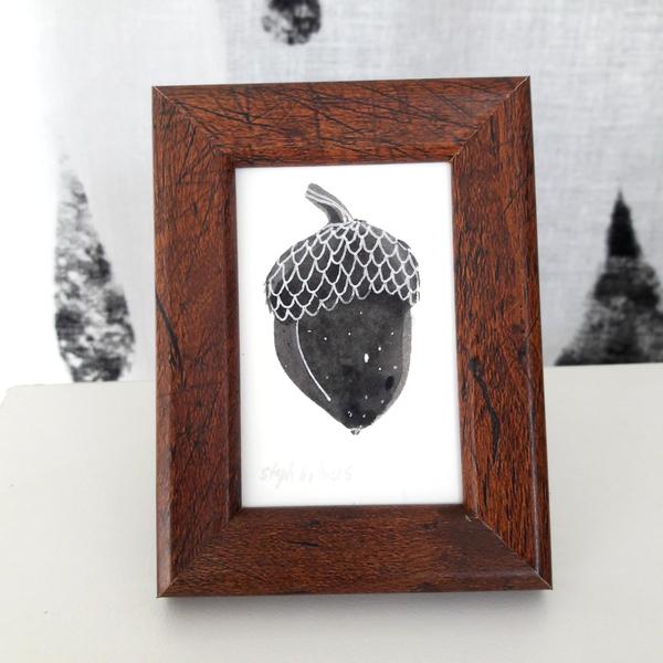 Image of a painted acorn in a wooden frame from Steph Holmes Art on a white table.