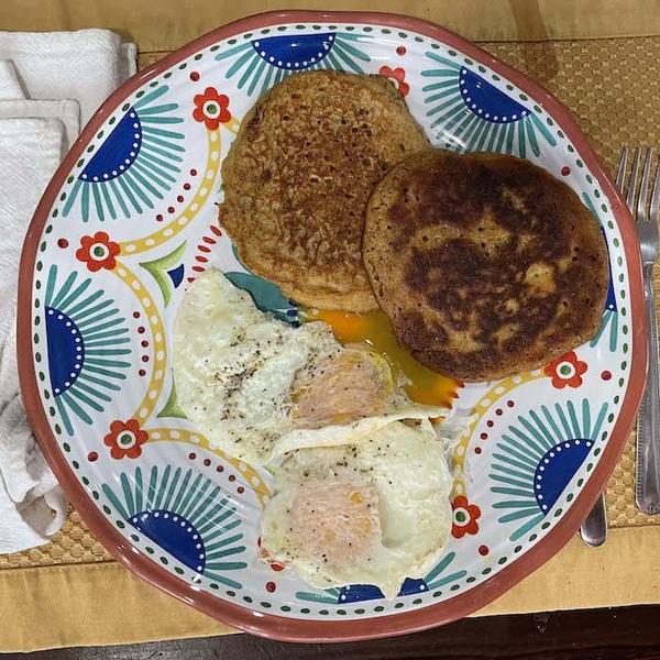 Oat Corn Pancakes shown with fried eggs