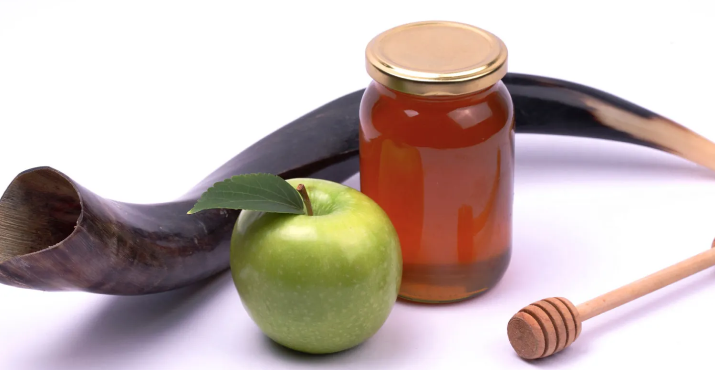 A jar of honey and an apple next to a banana
                                                
                                                Description automatically generated