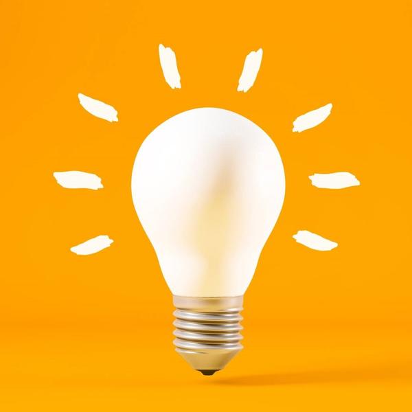 White lightbulb on orange background