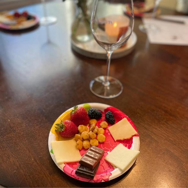 small plate with 3 cheeses, chocolate, berries, and crackers
