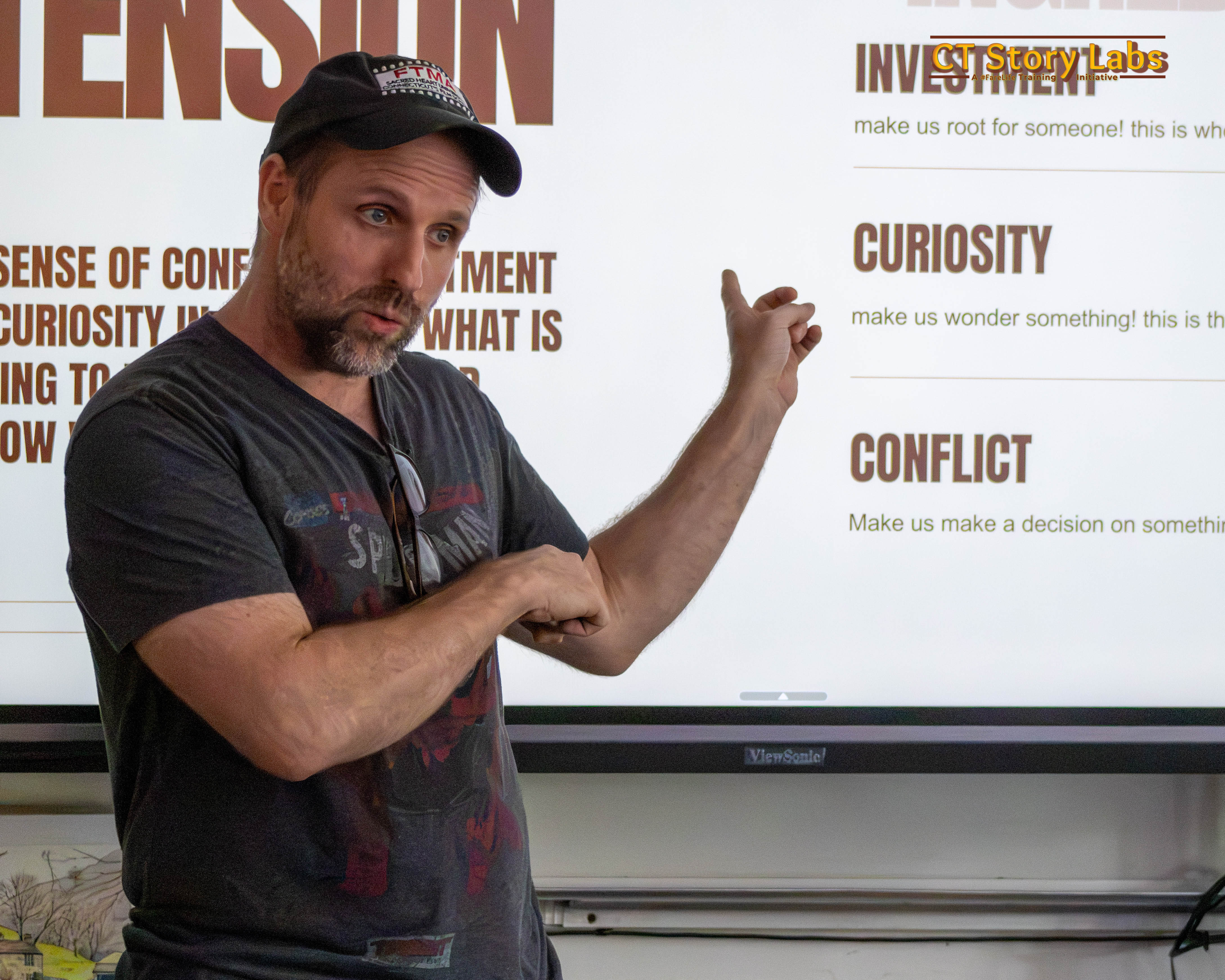 A CT Story Labs instructor teaching story structure — investment, curiosity, and conflict — to the crew