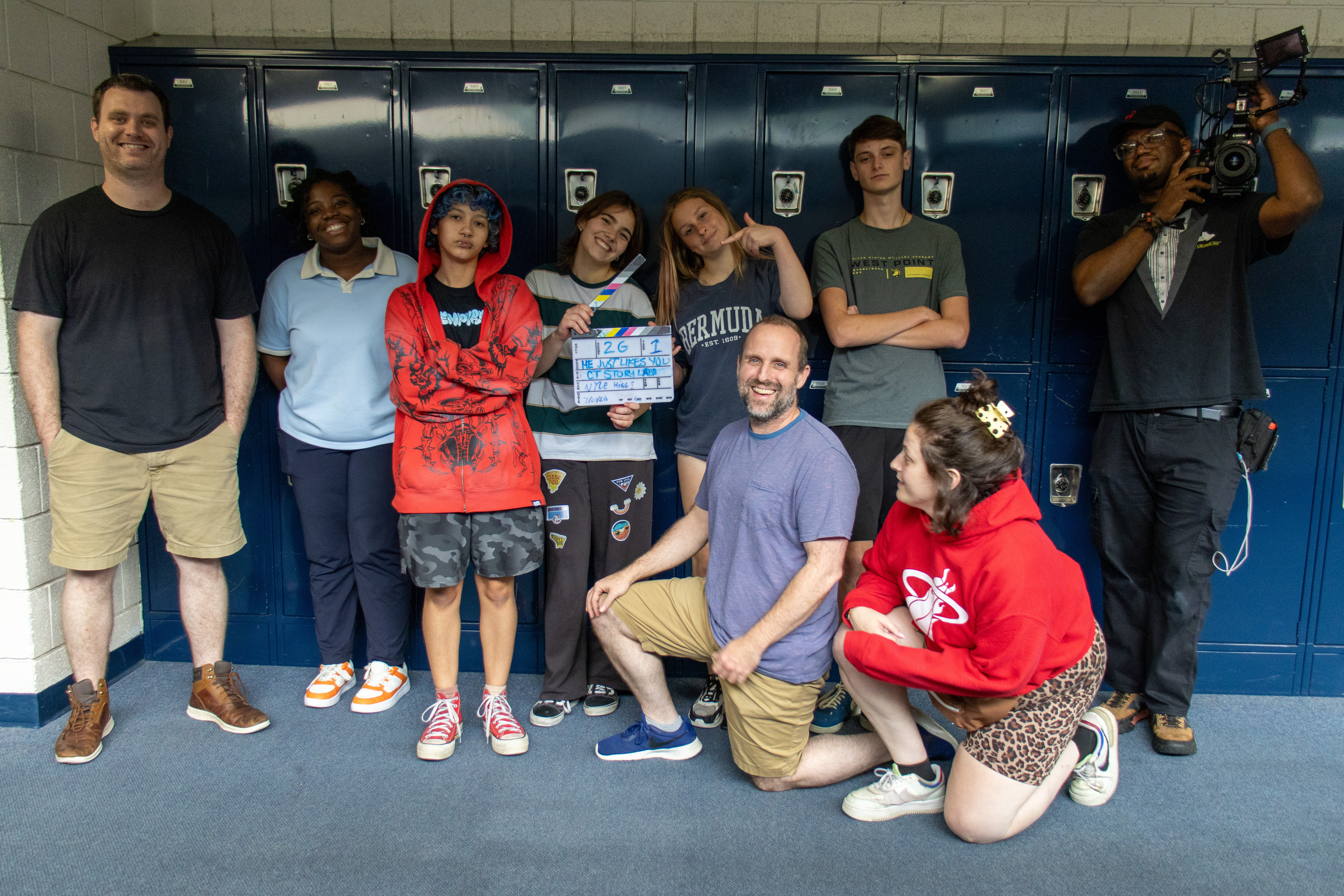 The full CT Story Labs student crew and instructors pose with the slate by the blue lockers