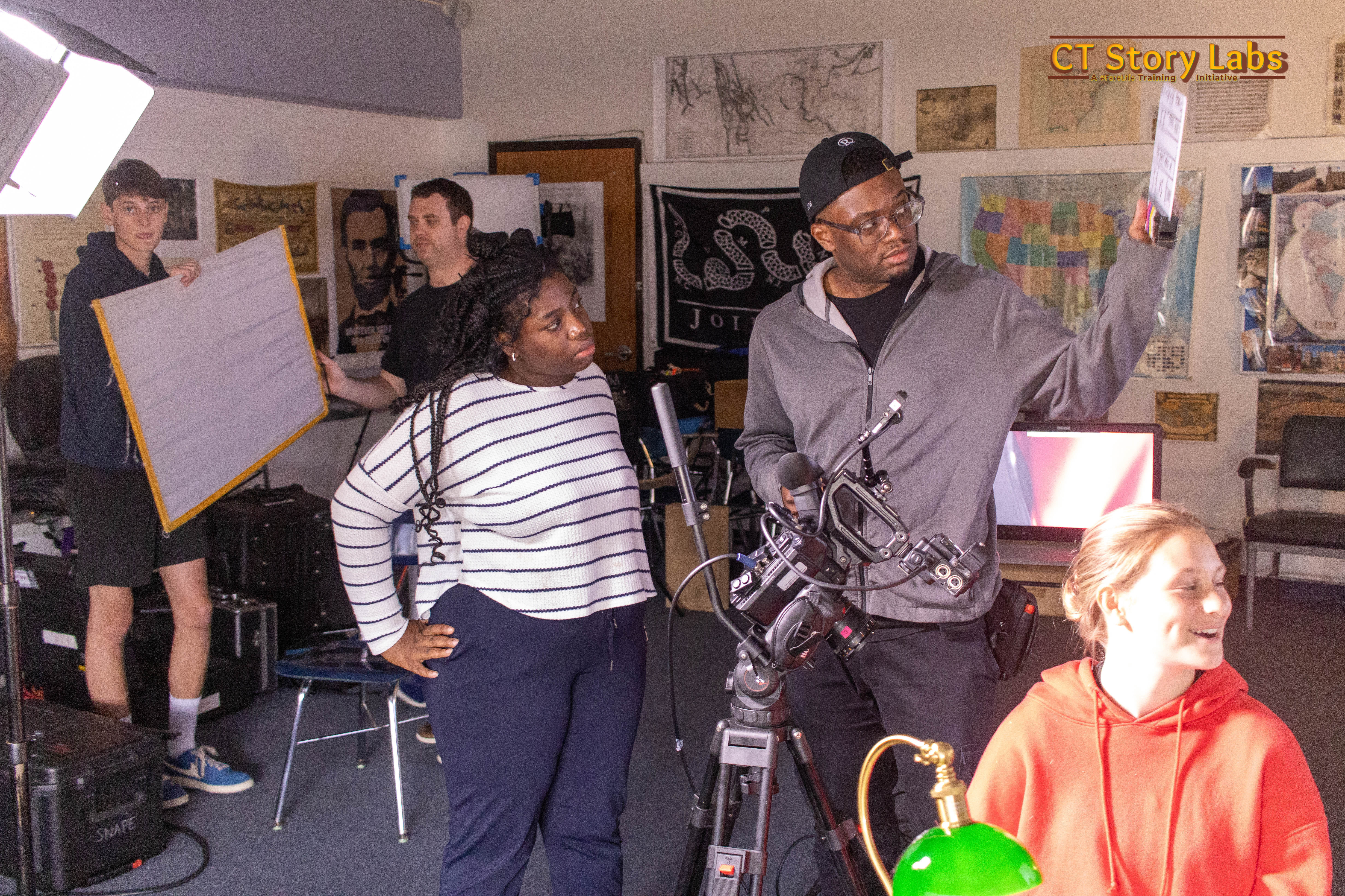 The crew setting up lighting and camera on a CT Story Labs production