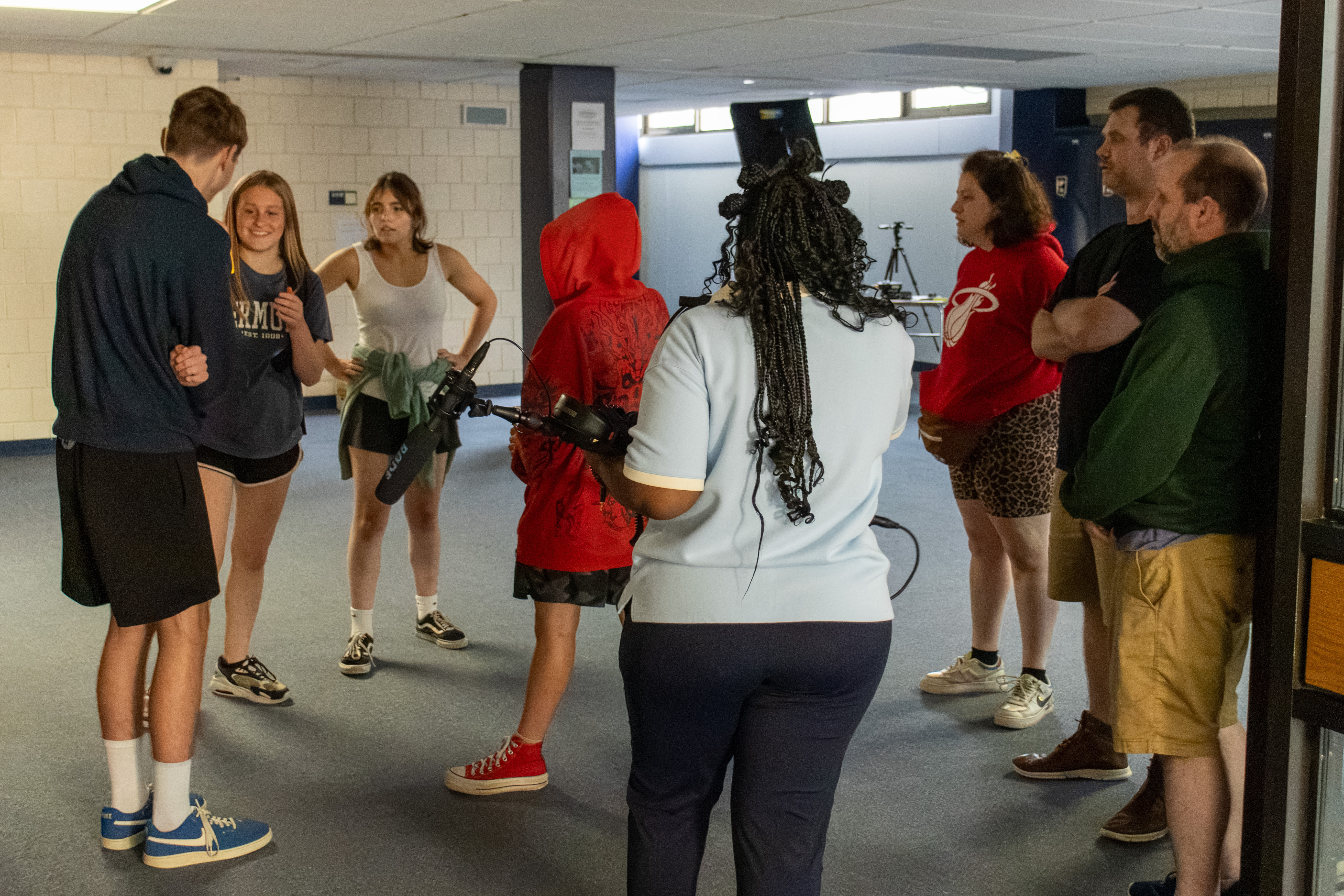 Participants and educators gathered around a boom mic and camera during a CT Story Labs scene exercise
