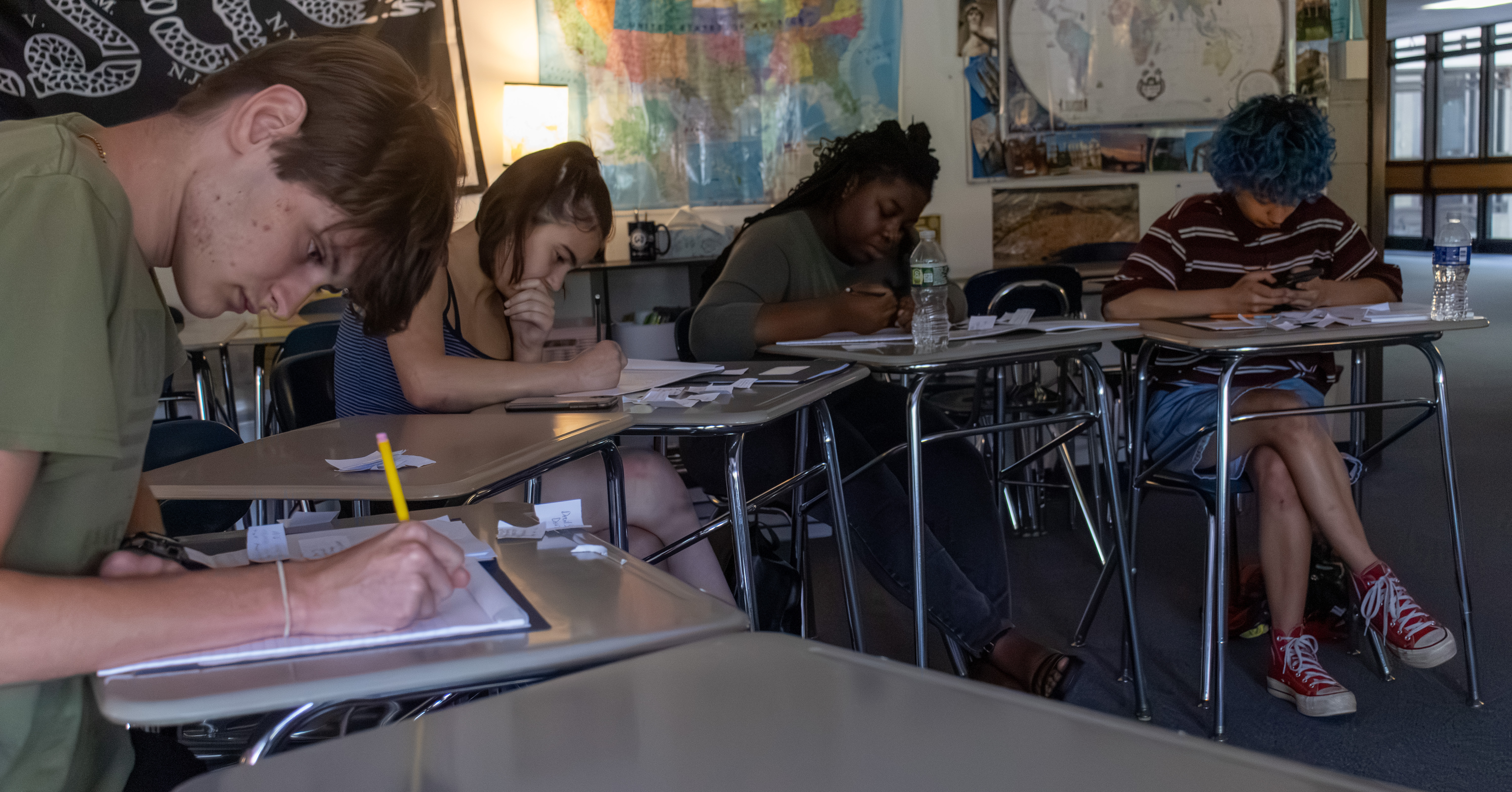 Students work through script pages at their desks during pre-production