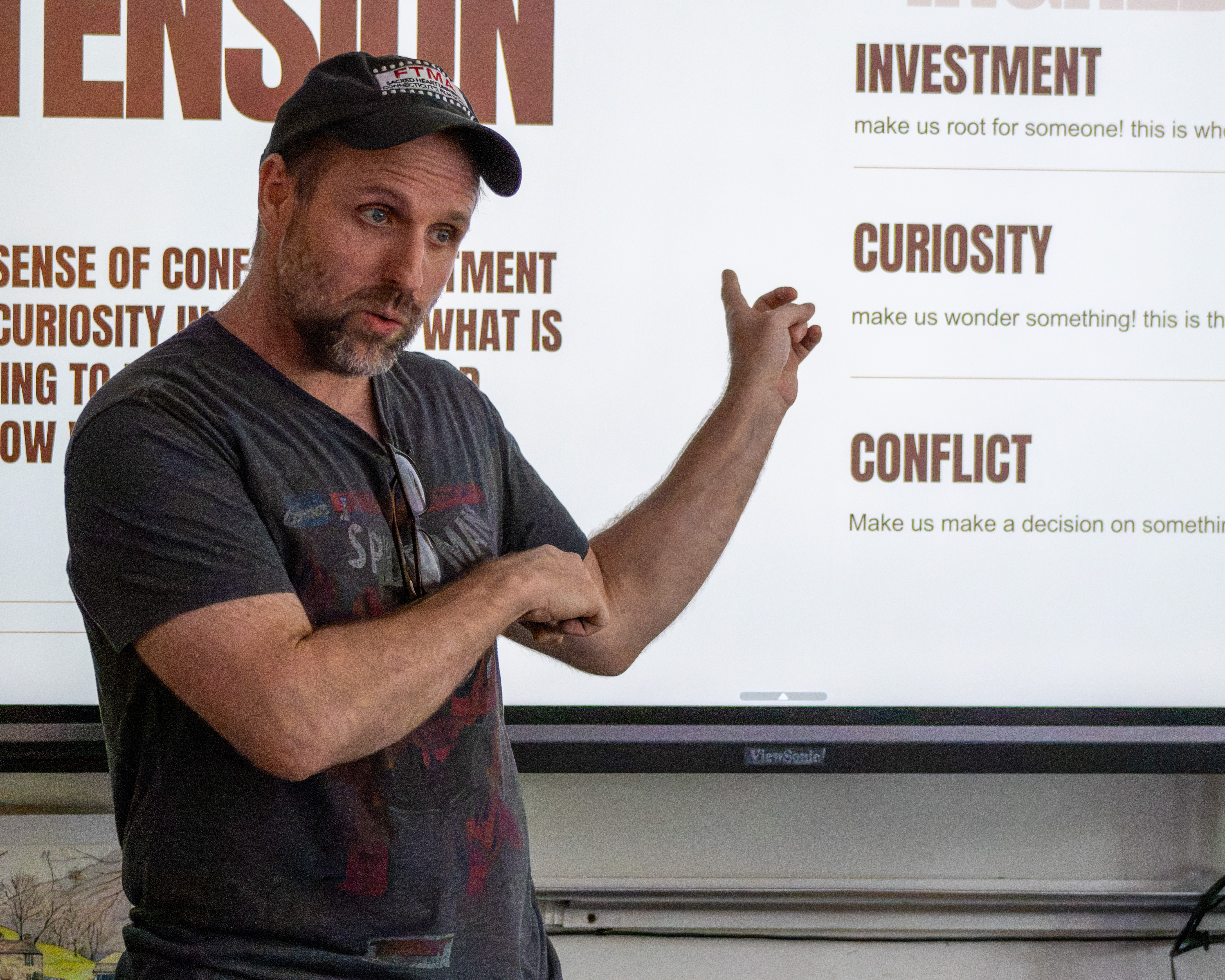 An instructor teaching story fundamentals at a whiteboard during a session