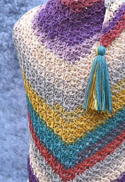 closeup of crochet triangle scarf in mandala yarn