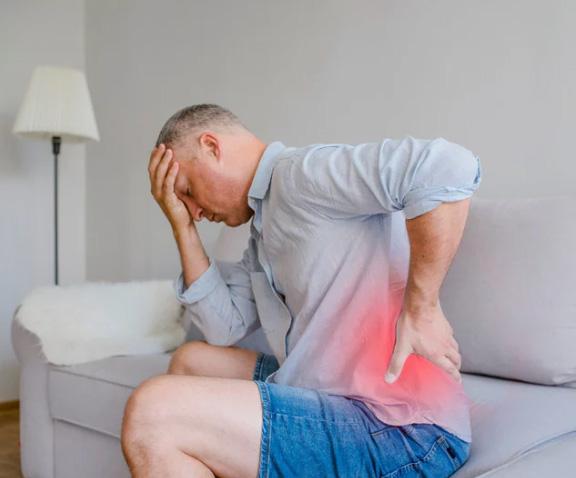 a person lying on his side is receiving medical massage therapy on his shoulder blade