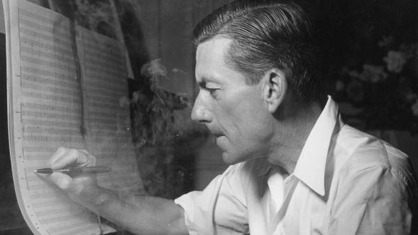 Hoagy Carmichael sitting at a piano, smoke wafting around him as he draws musical notes on music paper, supposedly writing "Stardust." 