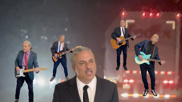 Screenshot from the video for Dream Not Found, with The King Teen singing in front of four guitar-playing The King Teens