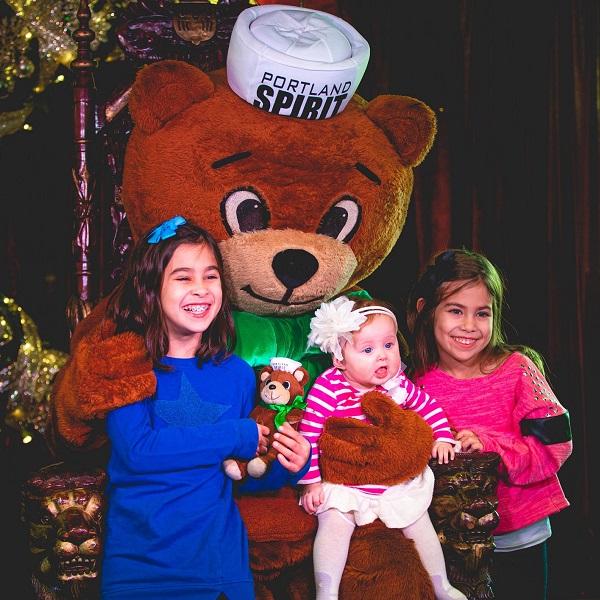 Children pose with Cinnamon Bear