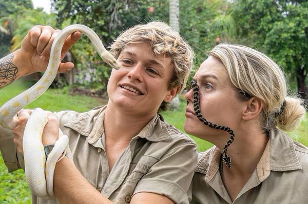 Bridget Thomson (right) with her twin Soph, shown here with non-venomous friends, now work as The Wildlife Twins.