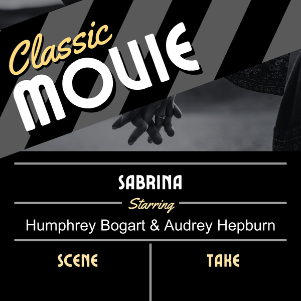 A black and white clapper with a couple holding hands in the background of the clapper. 