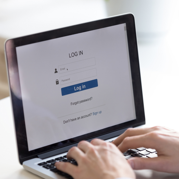 Someone logging in on a laptop.