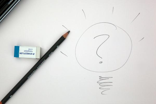 Photo of pencil, eraser, and question mark in a circle hand-drawn beside them.