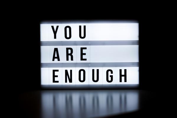 Illuminated "You are enough" sign.