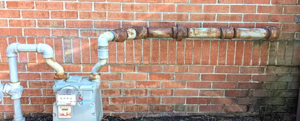 rusty natural gas pipe and gas meter