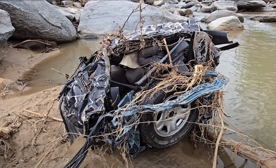 car transformed into a metallic boulder by a flood