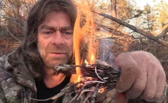 man burning twigs