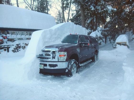 pickup truck buried in snow