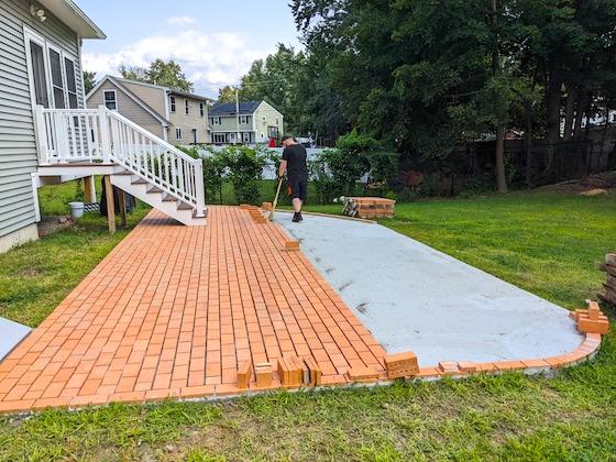 a brick paver patio being built in Nashua NH
