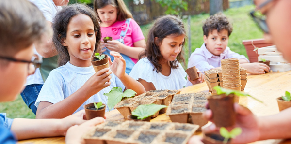 Children potting up plants as part of a children's activity