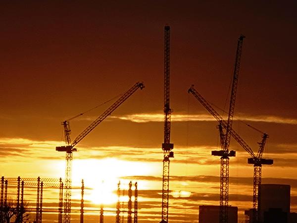 A group of people standing in a line holding up speech bubble type signs.