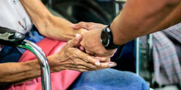 A man helping an older woman