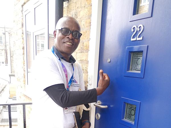 A group of people standing in a line holding up speech bubble type signs.