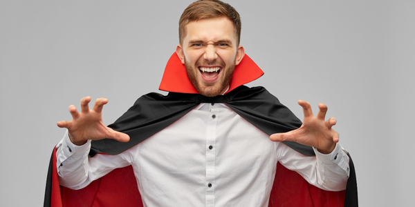 A man in a vampire fancy dress costume.