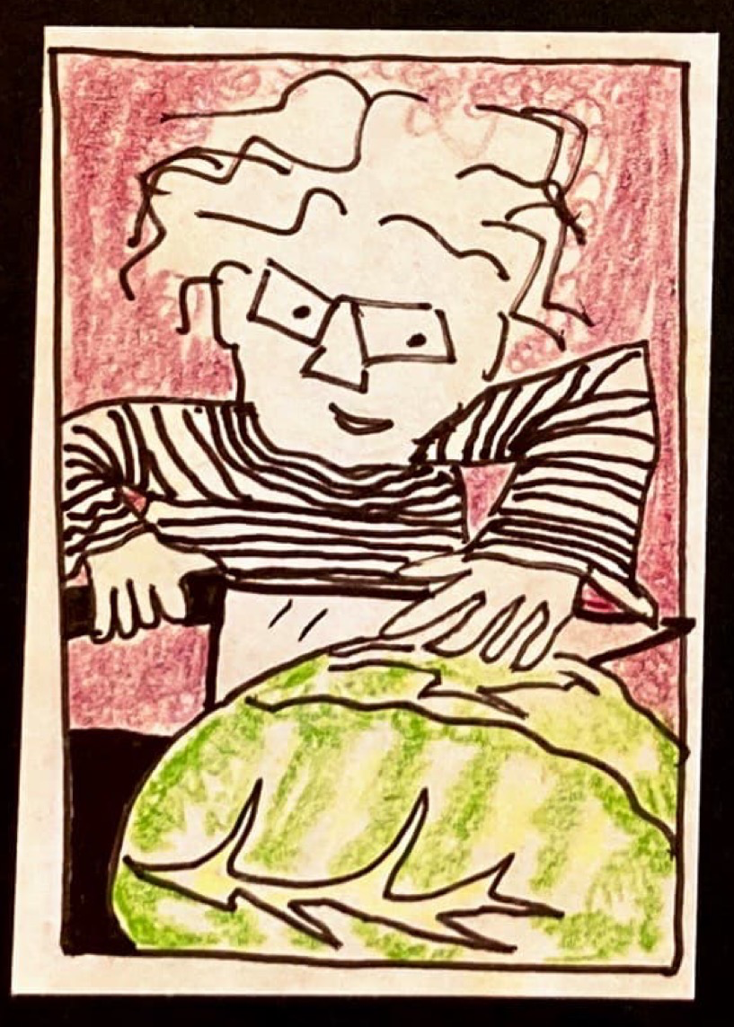 (Carolyn leaning on the knife to cut the giant cabbage in half.)