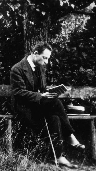 Portrait of Robert Frost seated outdoors