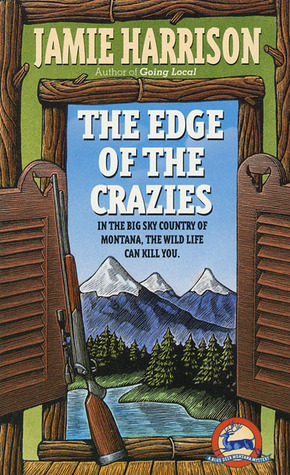 Book cover of The Edge of the Crazies by Jamie Harrison showing mountains, trees, and water as seen through a window with a log frame and a rifle propped up against the frame on the left.