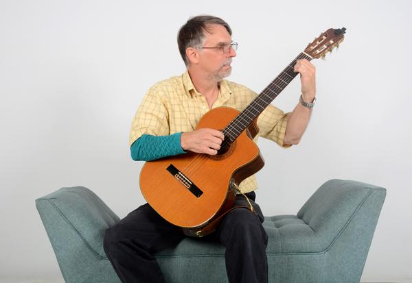 Brian Higgins playing a classical guitar