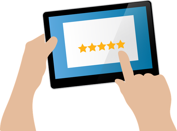 hands holding tablet with 5 stars