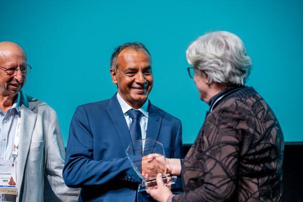 Professor Shabir Madhi receiving his Robert Austrian Award from Professor Keith Klugman of the Gates Foundation and Cynthia Whitney, ISPPD President and CHAMPS PI