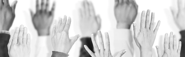 Many diverse people raising their hands