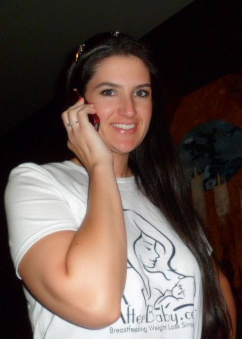 Amber smiling on the phone in her AfterBaby t-shirt, personally supporting a mom