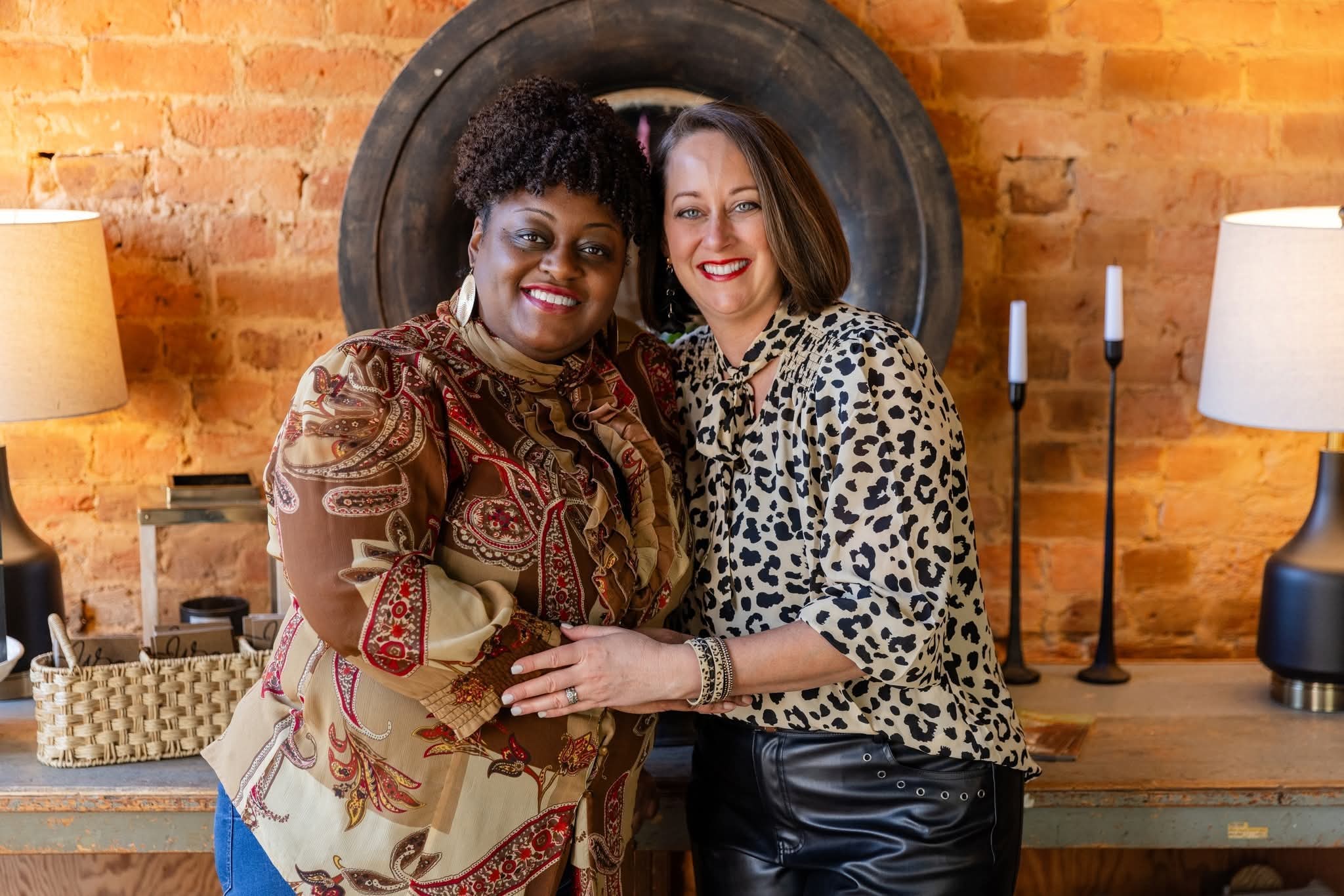 Anjetta King-Boyd and Danielle Stanley smiling together in front of a brick wall