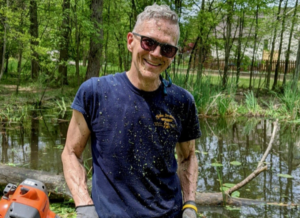 Jim covered in muck. Smiling through the stink!
