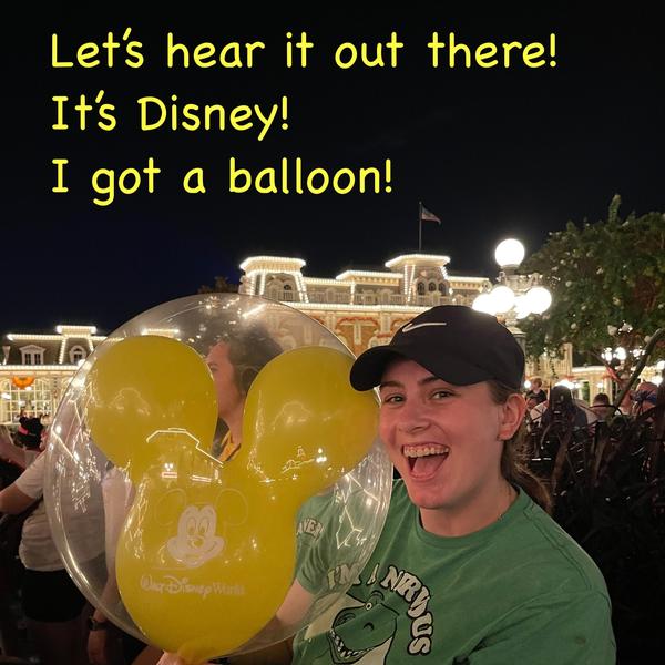 Picture of smiling girl with a Mickey Mouse balloon at Disney