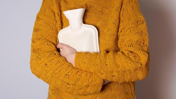 Someone holding a hot water bottle