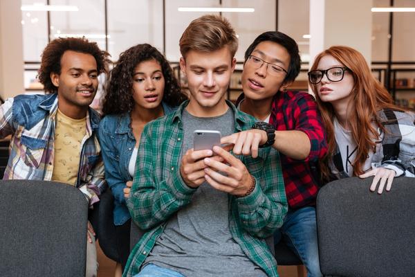 Young people around a phone